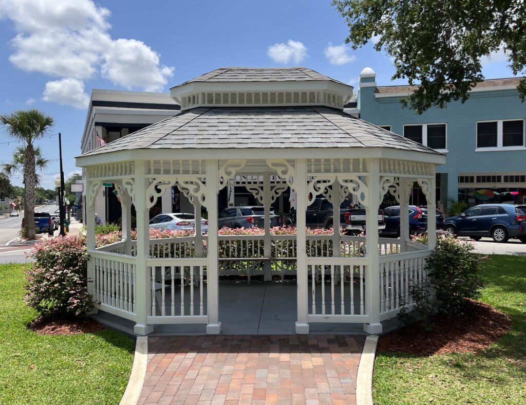 white gazebo with flowers around